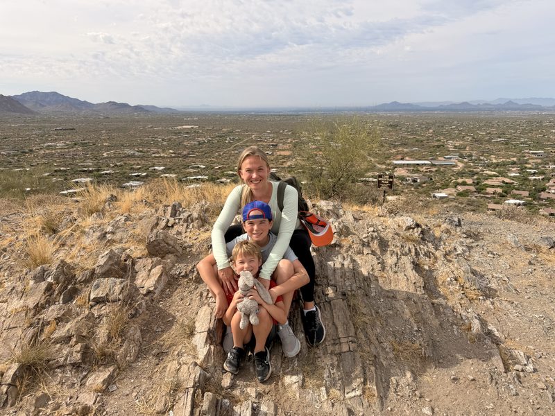Courtney with her kids hiking at Lone Mountain Peak